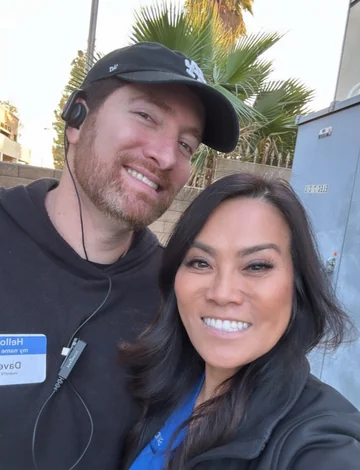 David Price wearing a production headset with Dr. Sandra Lee outdoors