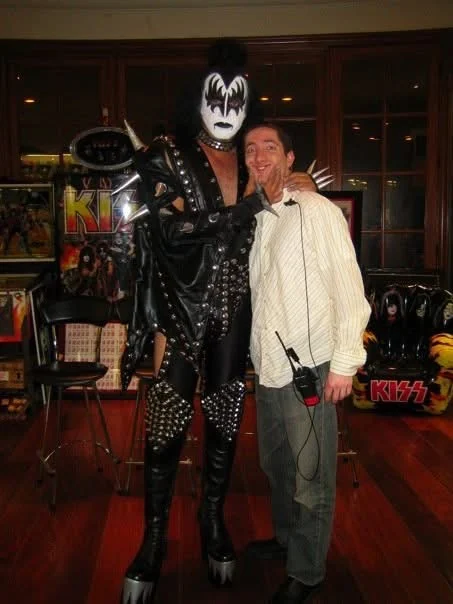 David Price wearing a production headset with Gene Simmons in KISS costume.