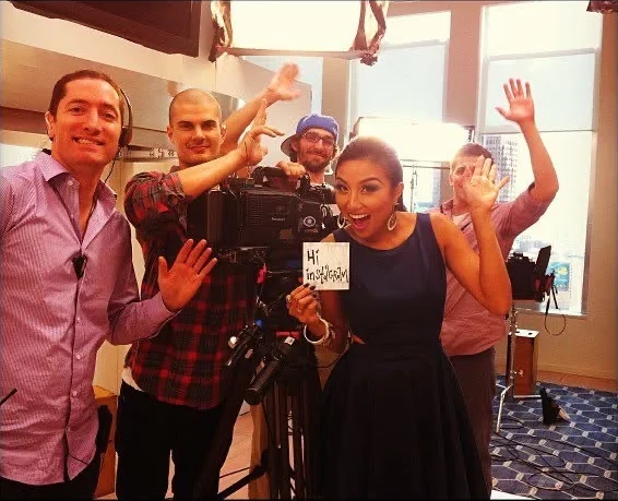 David Price, Jeannie Mai and the How Do I Look? crew gathered around a production camera.