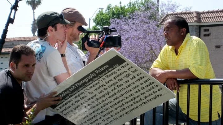 The Peacemaker production crew prepares an outdoor interview with on-camera talent.